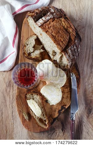 Still life: french Goat cheese country bread and glass of red wine. Top view rustic style