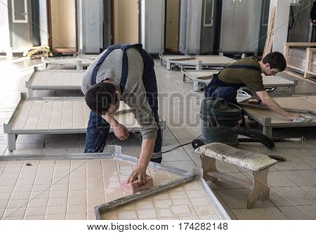 Workers Assemble Shower Cabins Ship