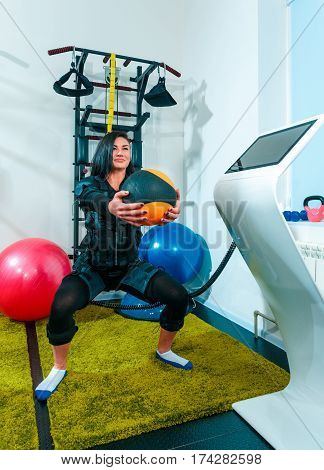 The female athlete doing they exercise in the EMS fitness studio