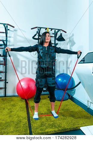 The female athlete doing they exercise in the EMS fitness studio