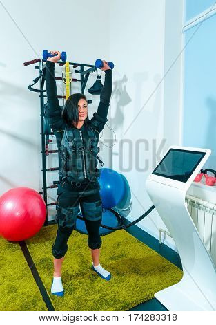 The female athlete doing they exercise in the EMS fitness studio