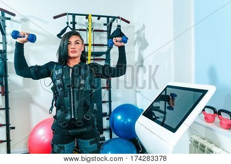 The female athlete doing they exercise in the EMS fitness studio