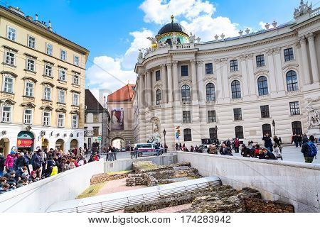 Vienna, Austria - April 3, 2015: Michaelerplatz in Vienna and people looking at the medieval ruins