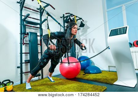 The female athlete doing they exercise in the EMS fitness studio
