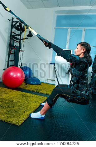The female athlete doing they exercise in the EMS fitness studio