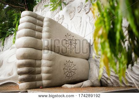 Foots with buddhist Swastika of Lying sleeping Buddha on the lotus in Long Son Pagoda, Nha Trang, Vetnam. The face of Buddha o the road to nirvana