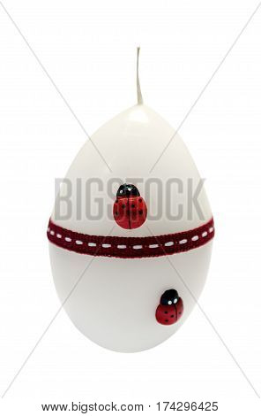 white candle with ladybug in the from of eggs isolated white background