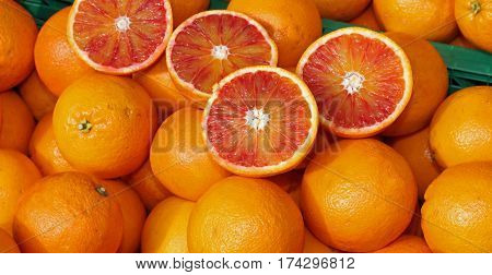 Ripe Oranges And An Orange Cut In The Stall Of Greengrocer