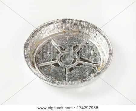 Used round tin foil cake pan on white background