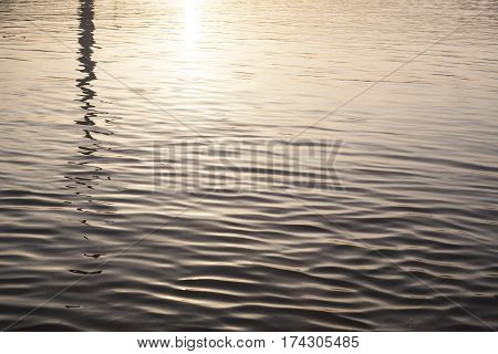 Difuse bright river water reflection at sunset