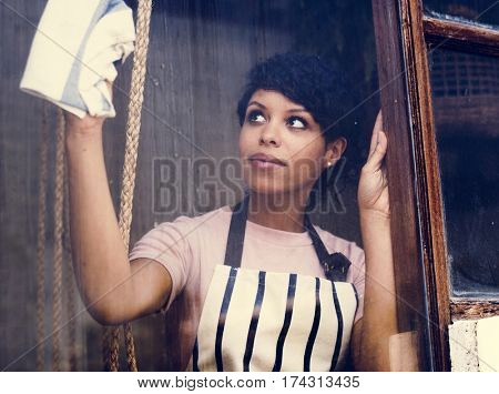 African Descent Woman Cleaning Wiping Shop Glass