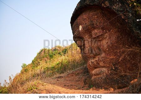 Stone Buddha Head at the mountain near Gokarna, Karnataka, India