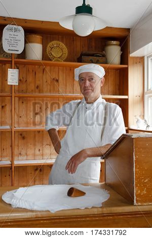 IRONBRIDGE UK - CIRCA 2013: Baker at the Victorian Bakery shop store in Blists Hill Museum Ironbridge Shropshire UK