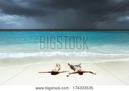 Idyllic photo of happy couple relaxing on white beach and tranquil sea backdrop. Space for text