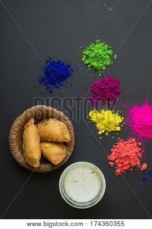 Holi- festival of colors. Gujeeya and flavoured milk with splash of powder colors. Holi festival is celebrated in India by consuming milk with Bhang and splashing colors in each others.