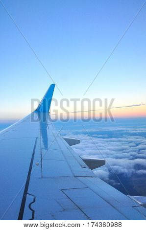 sunset clouds and sky as seen through window of an aircraft