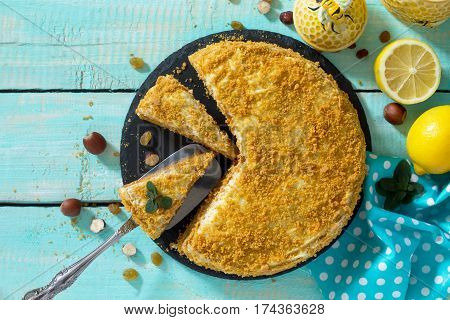 Sweet Home Layered Honey Cake On A Wooden Table With Raisins And Nuts. Top View, Copy Space.
