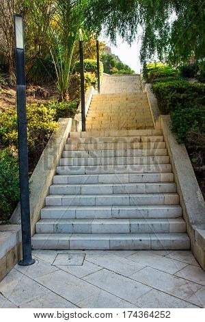 Staircase leading up to Santa Barbara mountain fortress in Ereta park Alicante Costa Blanca green trees summer