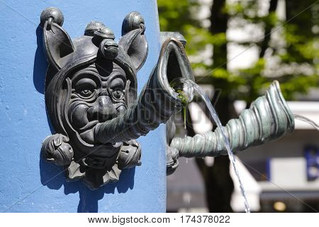 LUCERNE SWITZERLAND - MAY 06 2016: Fritschi Fountain detail that is a part of a pillar it is a type of tap from which body the water flows out.