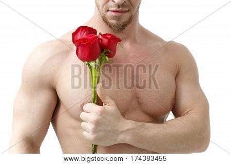 Handsome man holding a red rose and a bouquet of red roses. Sexy man gives a rose on a white background with a beautiful light. Isolated on white background