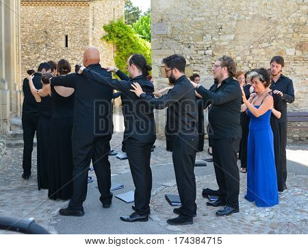 VAISON LA ROMAINE FRANCE - AUGUST 4 2016: Choral singers make a massage of each other before the performance. Relaxation.