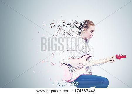 Side view of a girl wearing a white shirt and jeans and playing an electric guitar. She is made of a jigsaw puzzle. Mock up.