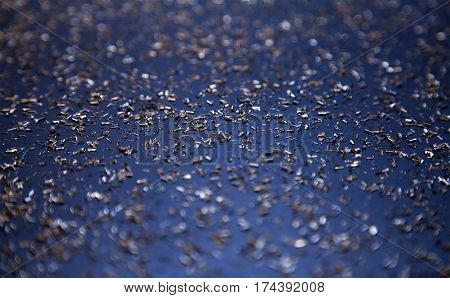 Gold shrapnel on a blurry blue background