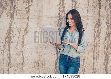 Portrait Of Young Happy Blogger With Modern Laptop Near Stone Wall