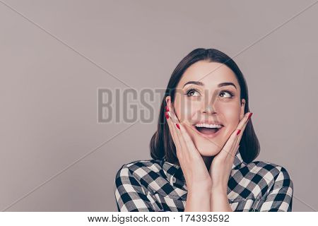 Portrait Of Young Smiling Impressed Cheerful Girl In Checkered Shirt Holding Her Hands Near Face