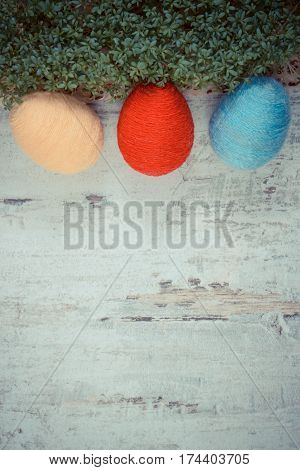 Easter Eggs Wrapped Woolen String And Green Cress On Wooden Background, Copy Space For Text, Decorat