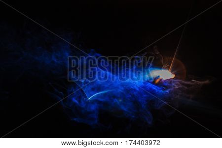 Metal Welding with sparks, Shielded metal arc welding (SMAW) process.