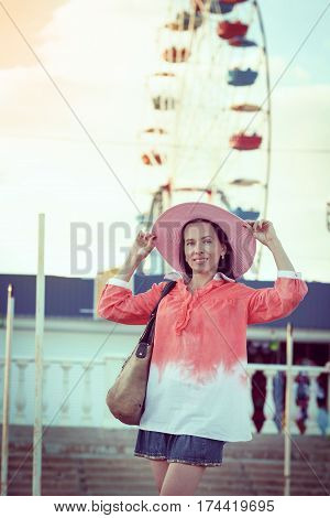 girl in red dress goes to the Ferris whee