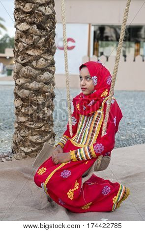 Muscat Oman February 4th 2017: young omani girl on a swing