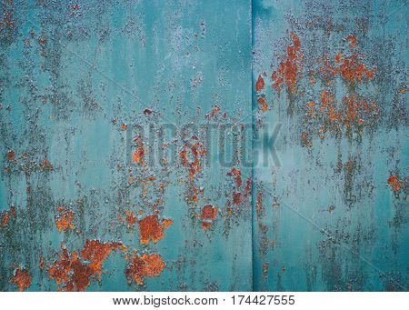 Vintage background. Old iron sheet painted in blue paint. The paint peeled off. in the ability to make some places rusty sheet. Traces of rust in several places