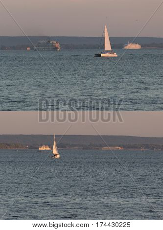 distant sailing boats on the water. vertical