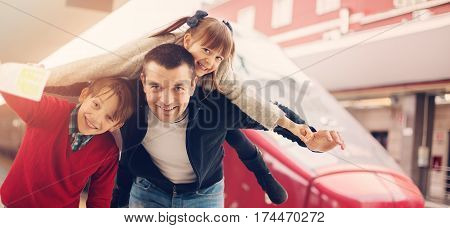 Happy family at a train station, travel concept