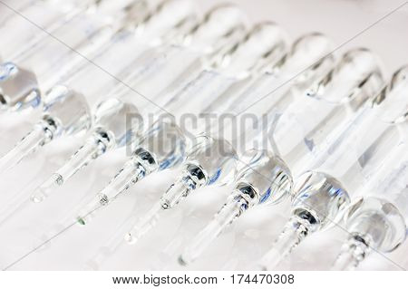 Row of transparent medical ampules in package. Close up