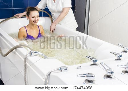 Young woman during hydromassage in beauty salon