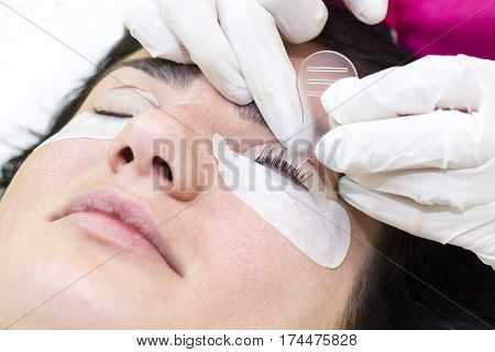 Woman on the procedure for eyelash extensions, eyelashes lamination