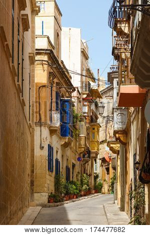 Traditional narrow street in Malta. Maltese architecture in Valletta, Malta