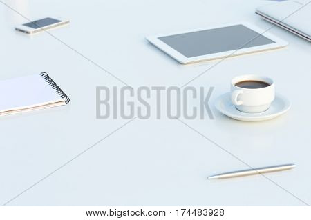 White working Place with Electronic Gadgets Paper Notepad Pen and Coffee in soft Tones with Copy Space