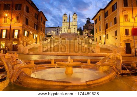 famous Spanish Steps with boat fountain illuminated at blue night, Rome, Italy