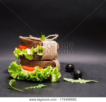 Healthy eating breakfast concept food background. Closeup of vegetarian sandwich on slate board.