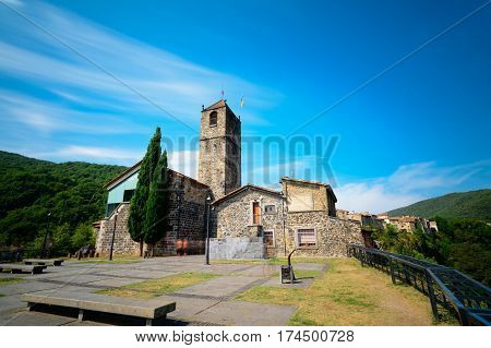 Castellfollit de la Roca, a municipality in the comarca of Garrotxa, Province of Girona, Catalonia, Spain. The basalt crag where the town is situated is over 50m high and almost a kilometre long.