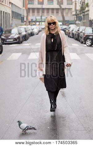 MILAN ITALY - FEBRUARY 23: Fashionable woman poses outside Les Copains fashion show during Milan Women's Fashion Week on FEBRUARY 23 2017 in Milan.