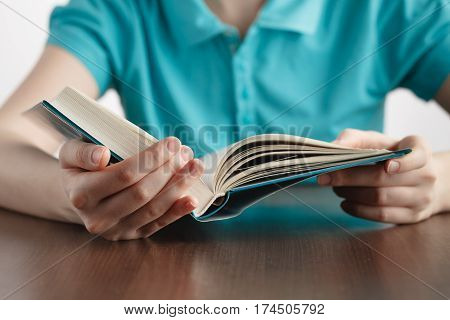 closeup of girls hands while reading book