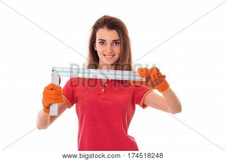 young girl holding a tool to repair the apartment and smiling isolated on white background