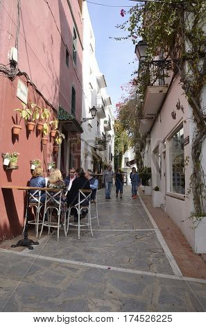 MARBELLA, SPAIN - FEBRUARY 27, 2017: People outside a barin an alley of the historic center of Marbella a city of the province of Malaga Andalusia Spain.