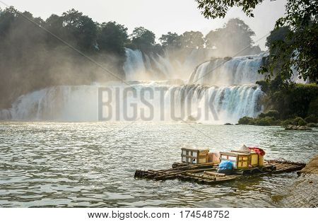 View At Detian Waterfalls With Bamboo Raft On Water