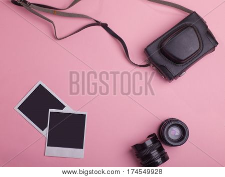 blank photo frames vintage photo camera bag lenses around blank copy space isolated on pink background flat lay